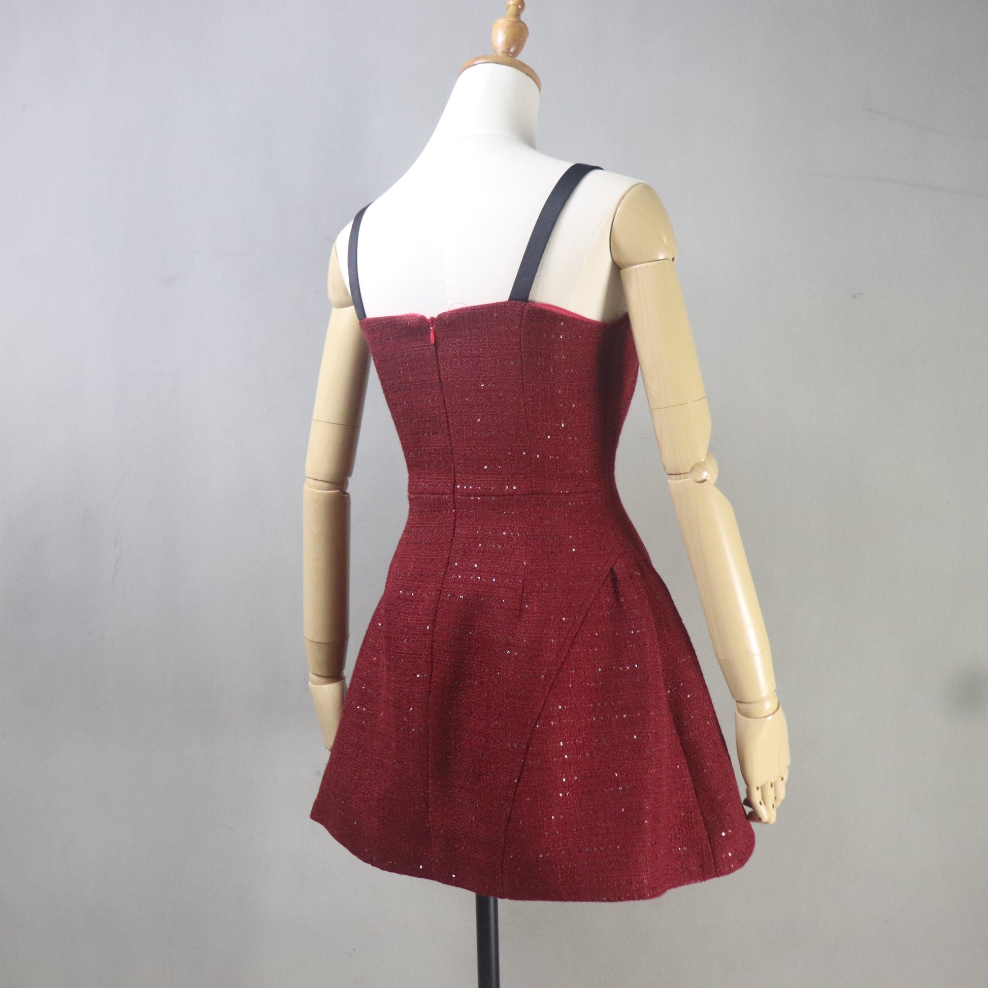 Red dress on a mannequin against a gray background