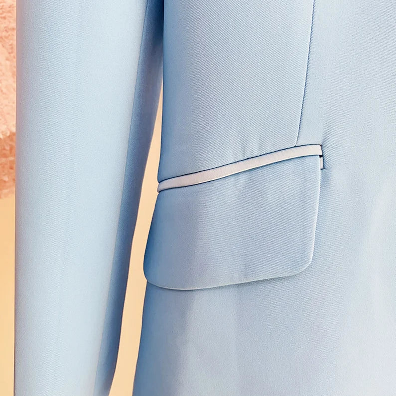 A great outfit for office wear could be a Light Blue Flare Trouser paired with a Women's Blazer in a One Button style. The flare trousers provide a stylish and flattering fit, while the light blue color adds a touch of sophistication and freshness to the outfit. The blazer, in a one-button style, adds structure and professionalism to the look, while also creating a cohesive and coordinated outfit when paired with the matching trousers. 