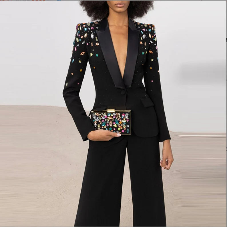 This timeless Women Black Hand Made Colorful Stones Embroidery Blazer + Mid-High Rise Flare Trousers Pantsuit Suit is perfect for any occasion. With its intricate hand-embroidered stones and sleek black blazer, this luxe two-piece set exudes elegant sophistication and is sure to make a lasting impression. Ideal for both day and night celebrations, it is the perfect reflection of refined luxury.