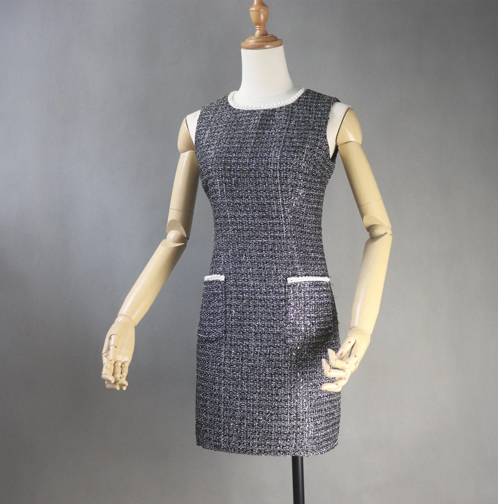 This dazzling FASHION Sequinned tweed little dress will stun everyone with its glamorous notes! This slim-fit black dress is made of a mid-weight tweed with dazzling lame accents, small sequins with white chiffon trims, and is lined with black satin. This dress also has a high neckline with trims, a sleeveless design,