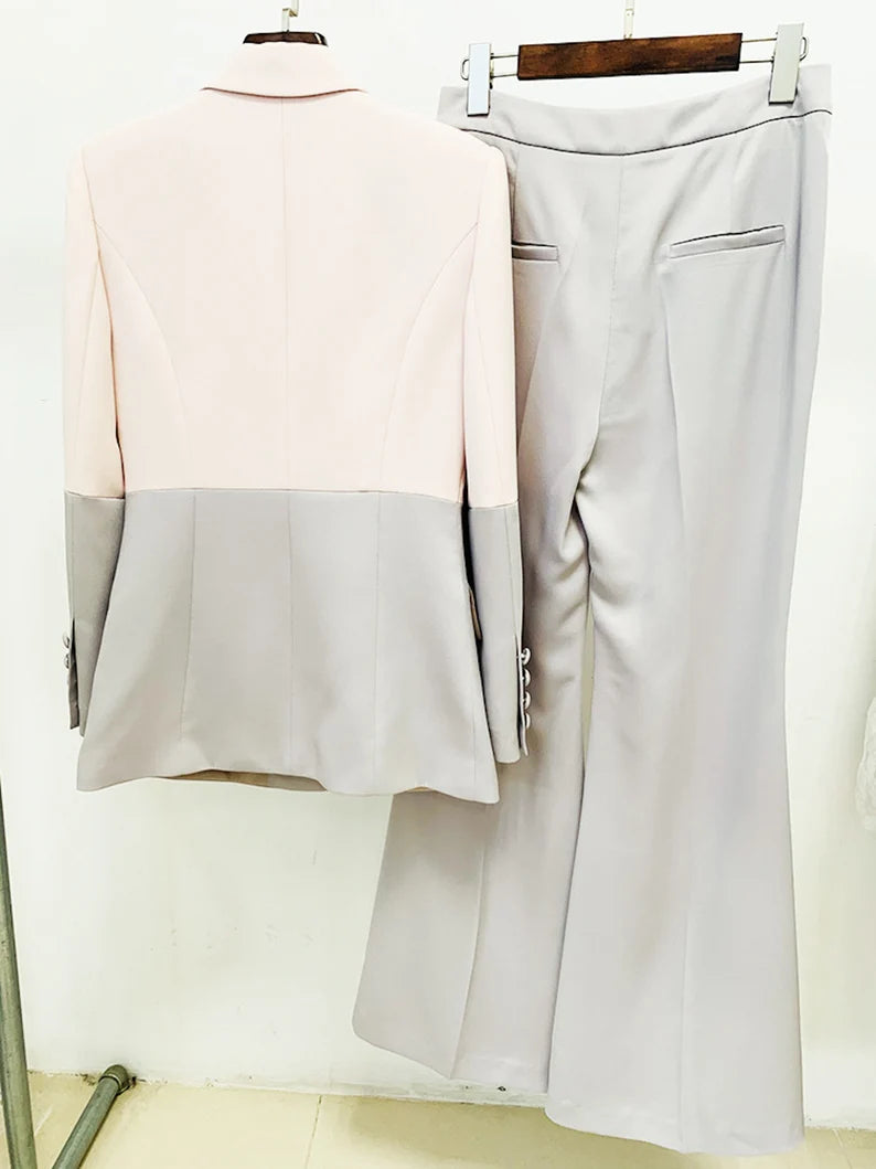 Women Light Pink / Light Grey Colour - Blocked Crash Blazer + Mid-High Rise Flare Trousers Suit Pantsuit This light pink and light grey colour blocked crash blazer with mid-high rise flare trousers suit pantsuit is perfect for any woman who wants to make a statement. The blazer is tailored to fit, and the trousers are designed for a modern, flattering fit. The light colors are classic, yet stylish and the details on the blazer make it stand out.