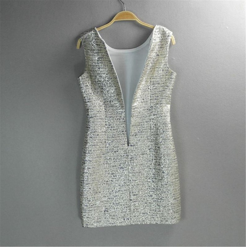  Step your way into any party this holiday season with their sliver Sparkly. Style with heels and a mini bag to complete the look. Fully lined ,front pocket and front pocket. This sleeveless silver sparkle dress is perfect matched with beautiful handbag or purse. Festive fashion at it s finest.