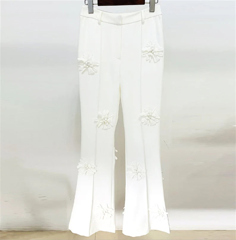 This appears to be a very fashionable and eye-catching pantsuit that would be ideal for a number of formal events. While the loose-fitting blazer and mid-high rise flare trousers provide comfort and freedom of movement, the white colour and 3D flower decorations are sure to make a bold statement.